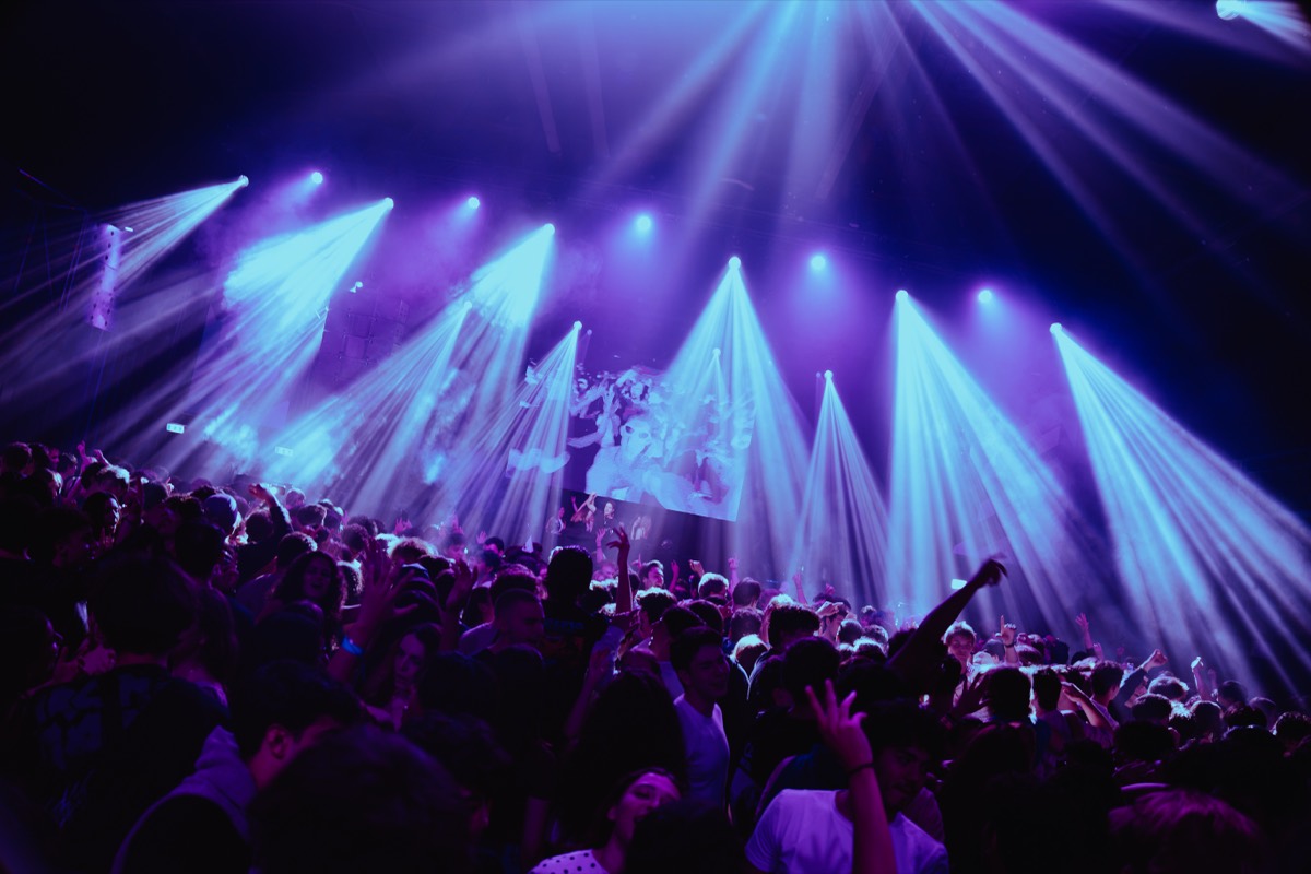 Blue light beams above the dance floor