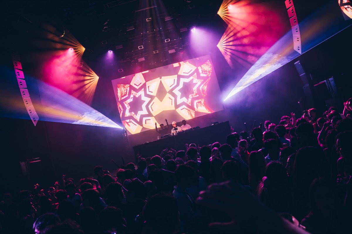 DJs performing in front of kaleidoscope stage visuals