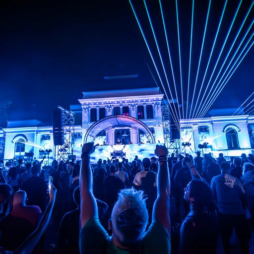 Crowd under blue lasers in front of the UNTOLD stage